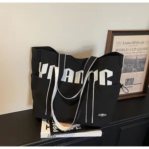 Grande borsa shopper in tela da donna, elegante borsa a tracolla nera con stampa.