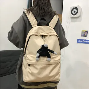 Casual nylon backpack for women and men, large capacity school bag with cute monkey pendant.