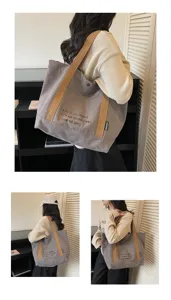 Detail view of large capacity canvas tote bag, showing shoulder strap and printed design.