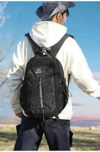 Outdoor tactical backpack detail showcasing durable grid fabric, elastic cords and mesh pockets.