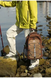 Detail view of the brown hiking backpack with bungee cord, suitable for outdoor sports.