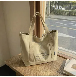 Canvas commuter tote bag detail presentation, large capacity casual shoulder handbag in khaki.
