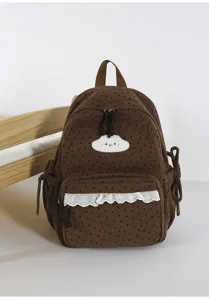 Detail view of the sweet brown corduroy backpack featuring a cute white cloud patch and lace.