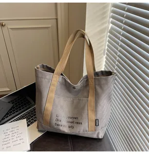 Gray canvas tote bag with beige straps, large capacity casual shoulder bag for daily commute.