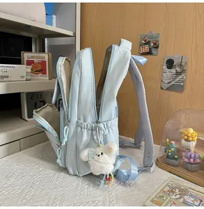 Light blue casual school backpack with cute plush pendant, multi-compartment design.