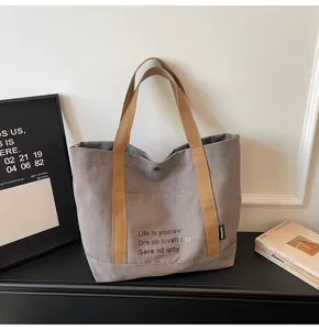 Casual canvas commuter tote bag for women, large capacity shoulder handbag daily style.