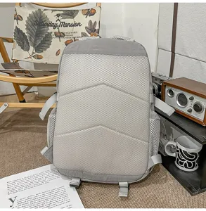 Grey casual backpack with breathable mesh back padding and shoulder straps for daily travel.