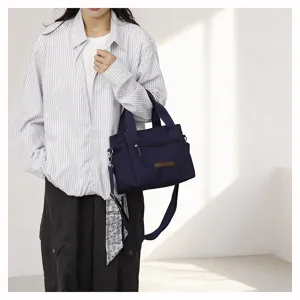 Detail view of the casual nylon shoulder bag for women, featuring durable straps and simple design.