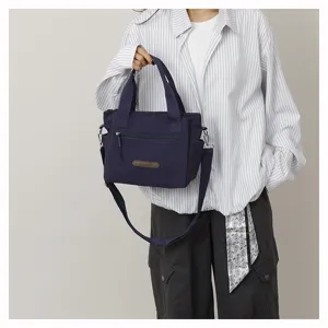 Casual nylon canvas shoulder bag for women, large capacity stylish tote bag for daily commute.