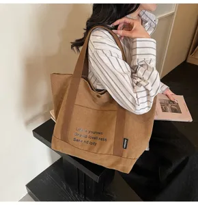 Casual canvas tote bag detail showing large capacity, brown shoulder bag for women daily commute.
