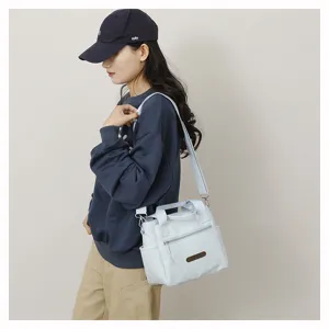 Casual nylon shoulder bag for women, lightweight crossbody tote with handy pockets.
