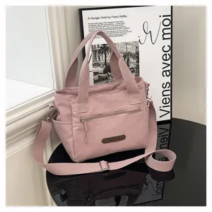 Casual pink nylon shoulder bag, lightweight casual handbag with large capacity and zip pocket.