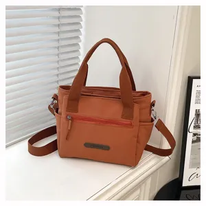 Casual nylon shoulder bag for women, large capacity daily commuter handbag with zipper pocket.