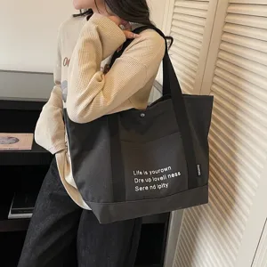 Large capacity canvas tote bag for women, casual commuter shoulder handbag for daily use.