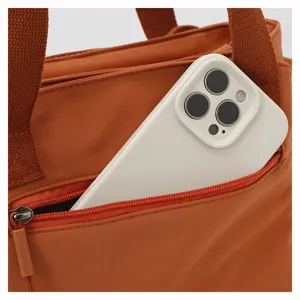 Detail view of casual nylon women shoulder bag, featuring practical zipper pocket design.