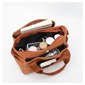 Detailed view of large capacity nylon shoulder bag interior compartments and storage.
