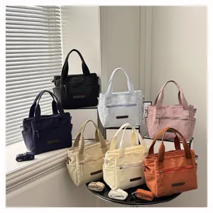Detailed display of multiple colored casual nylon tote bags showcasing design and pockets.