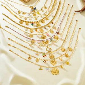Gold layered charm necklaces with pearls, evil eyes, and flowers, trendy aesthetic jewelry.