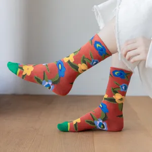 Retro floral mid-calf socks detailed view, showcasing vibrant red fabric with colorful flower prints and green toe.