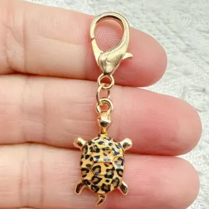 Cute leopard print turtle keychain and bag charm with gold lobster clasp pendant.