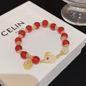Red bead rabbit charm bracelet, delicate gold metal spacer jewelry for women stylish gift.
