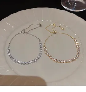 Elegant silver and gold slider tennis bracelets with sparkling square cubic zirconia stones.