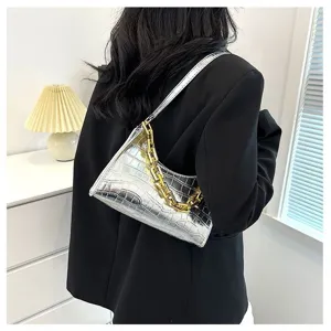 Detailed close-up view of silver metallic crocodile texture baguette shoulder bag with gold chain.