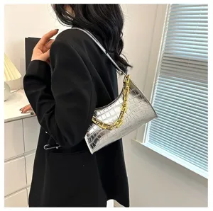 Silver metallic crocodile pattern baguette shoulder bag with luxury gold chain detail view.