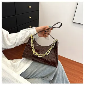 Brown crocodile pattern shoulder bag detail, elegant design with chunky gold chain, chic style.