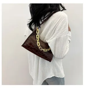 Trendy dark brown crocodile pattern baguette bag with stylish chunky gold chain underarm design.