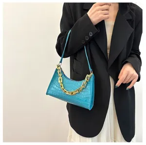 Details of the blue crocodile pattern baguette bag with stylish chunky gold chain decoration.