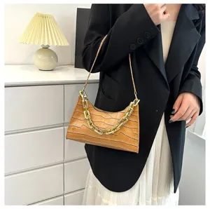 Detail view of stylish brown crocodile pattern baguette shoulder bag with chunky gold chain.