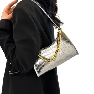 Trendy silver crocodile pattern baguette shoulder bag with stylish gold chain strap.