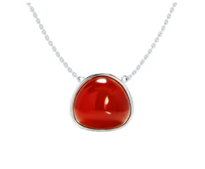 Detailed close-up view of silver chain necklace featuring irregular red gemstone bezel pendant.