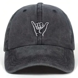Detail view of washed cotton baseball cap featuring gesture embroidery, dark grey color.