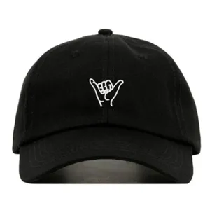 Close-up detail of the black washed cotton baseball cap featuring unique white hand gesture embroidery.
