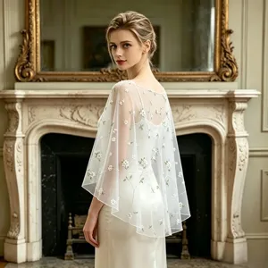 Elegant white sheer tulle cape with delicate floral embroidery, perfect for evening wear.
