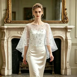 Detailed view of the sheer mesh cape with delicate floral vine embroidery for women.