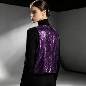 Close-up detail shot of a sparkling purple sequin vest worn over black for stylish layering.
