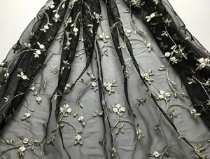 Detailed view of black mesh sheer fabric with delicate floral vine embroidery, lightweight texture.