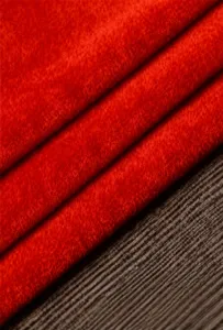 Red velvet fabric swatch detail, soft texture and rich color for custom costume making.