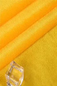 Yellow fabric material detail texture swatch close up, premium soft textile material for sewing.