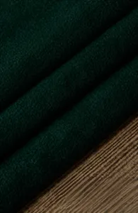 Dark green velvet fabric material detail swatch, soft texture display for custom sewing.