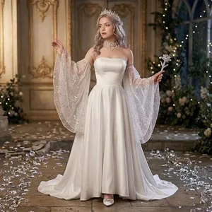 Detailed shot of elegant white off-shoulder wedding dress with glitter mesh sleeves.
