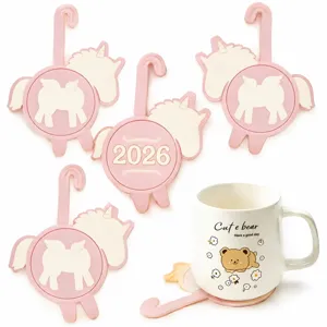 Detail view of cute cartoon pony silicone cup coasters with hanging hook and ceramic mug prop.