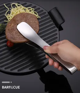 Stainless steel food tong detail shot, perfect for kitchen cooking, steak and outdoor barbecue use.