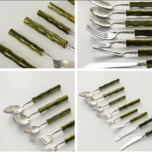 Stainless steel cutlery set detail view showing green bamboo handle steak knife, fork and spoon.