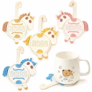 Cute 2026 cartoon horse silicone cup mats with hanging hooks and a matching ceramic mug set.