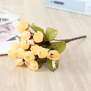 Detailed close-up shot of artificial mini yellow rose flower bouquet for event decoration.