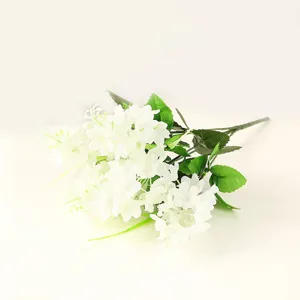 Detail shot of artificial white hyacinth flower bouquet, close up of realistic petals and green leaves.